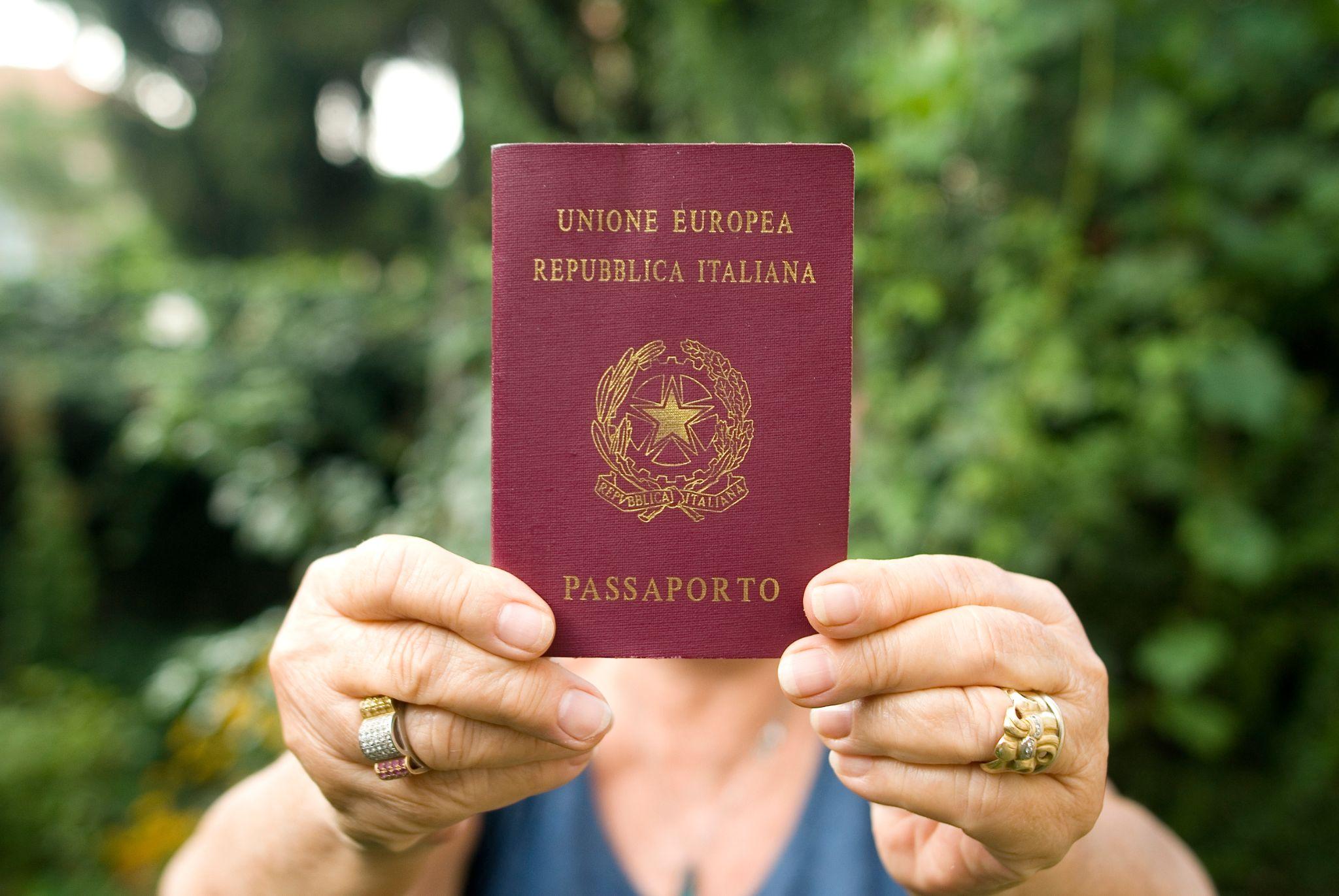 Holding up an Italian passport