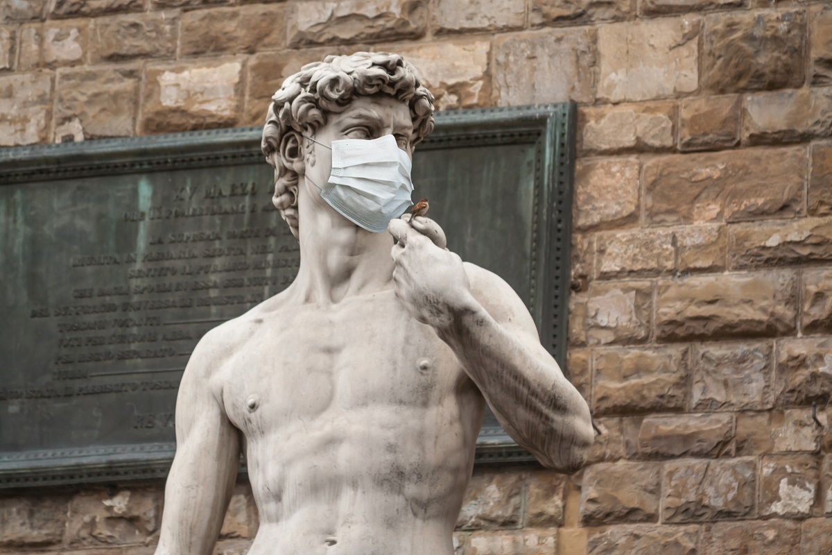 The Statue Of David in the Piazza della Signoria In Italy Wearing a Protective Face Mask