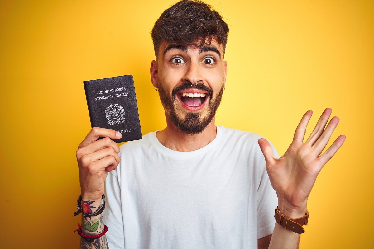 Young man with Italy Italian passport, very happy and excited
