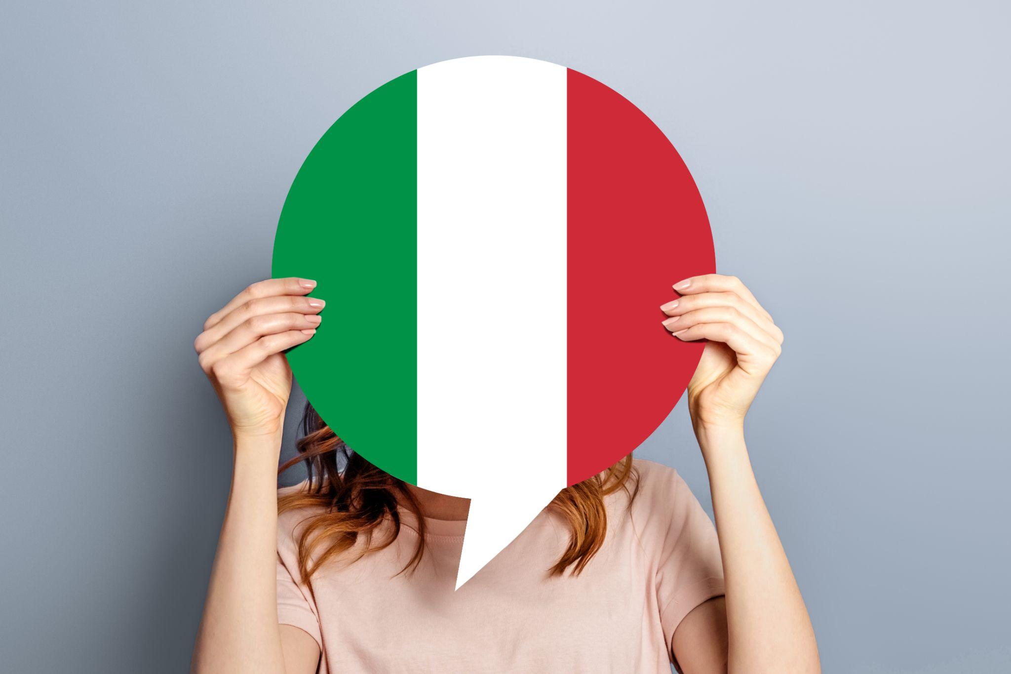 A woman holding an Italian flag shaped like a speech bubble