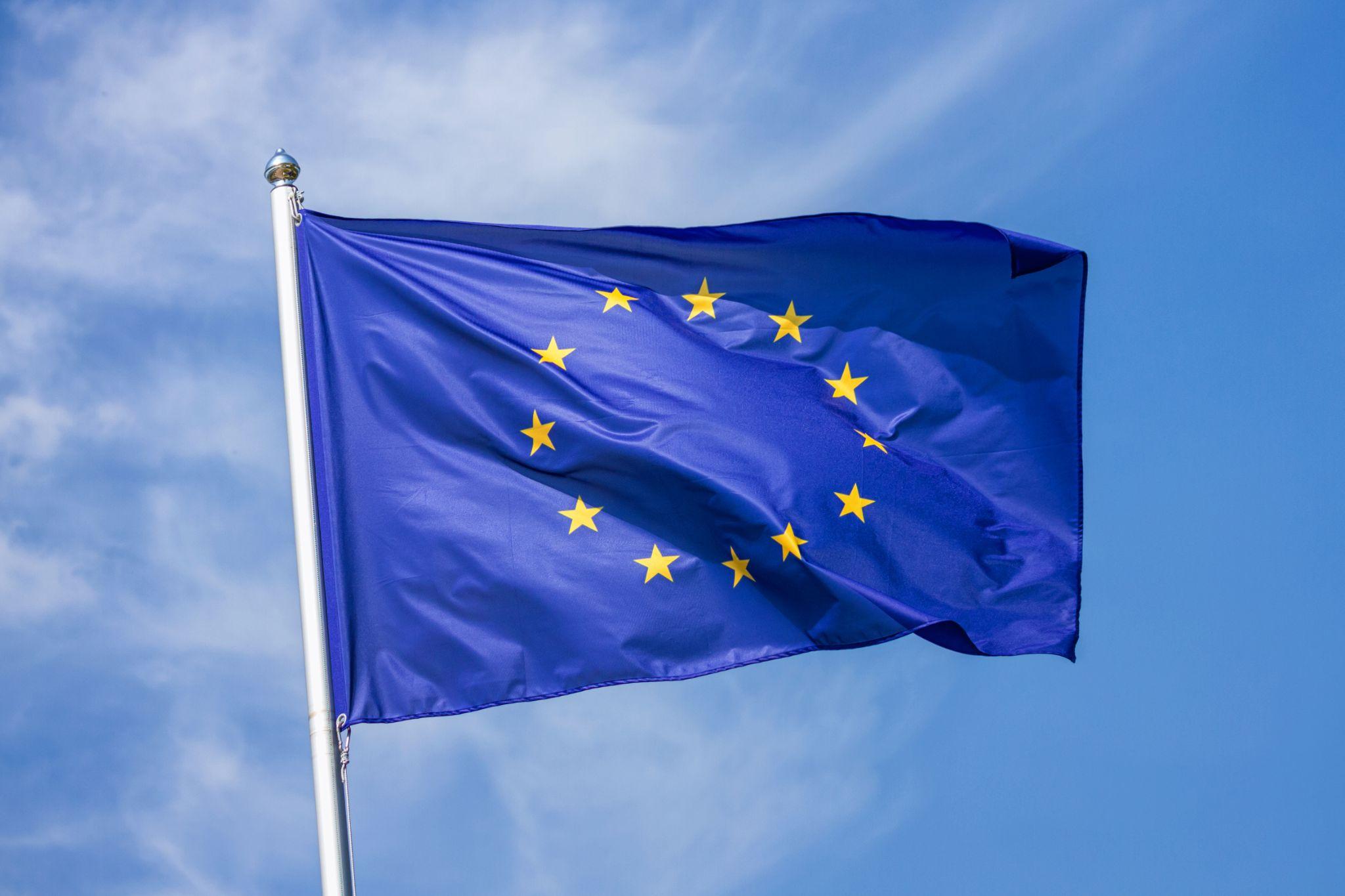 An EU flag against a blue sky
