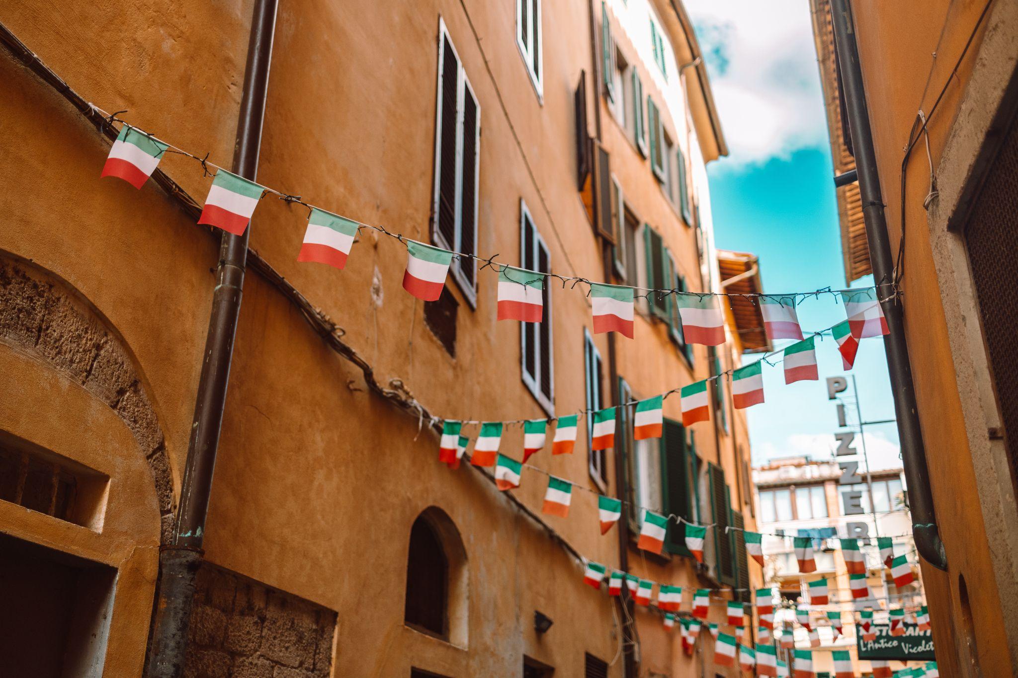 An Italian alley with Italian flags hanging up