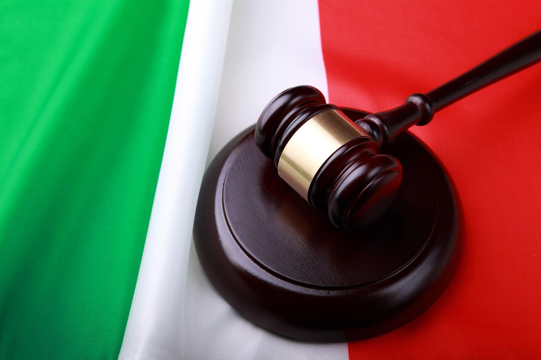 A legal gavel on an Italian flag