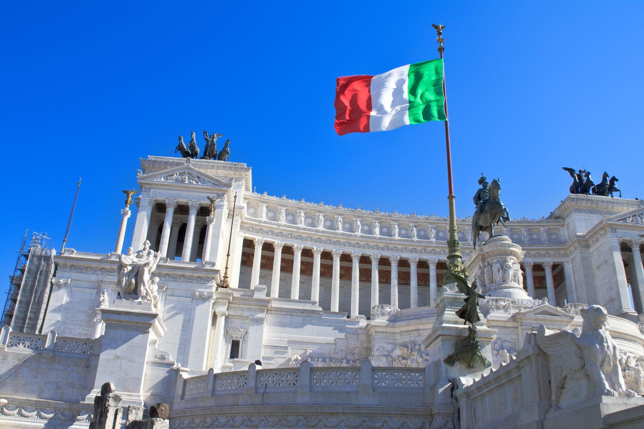 A historic Italian building with a flag
