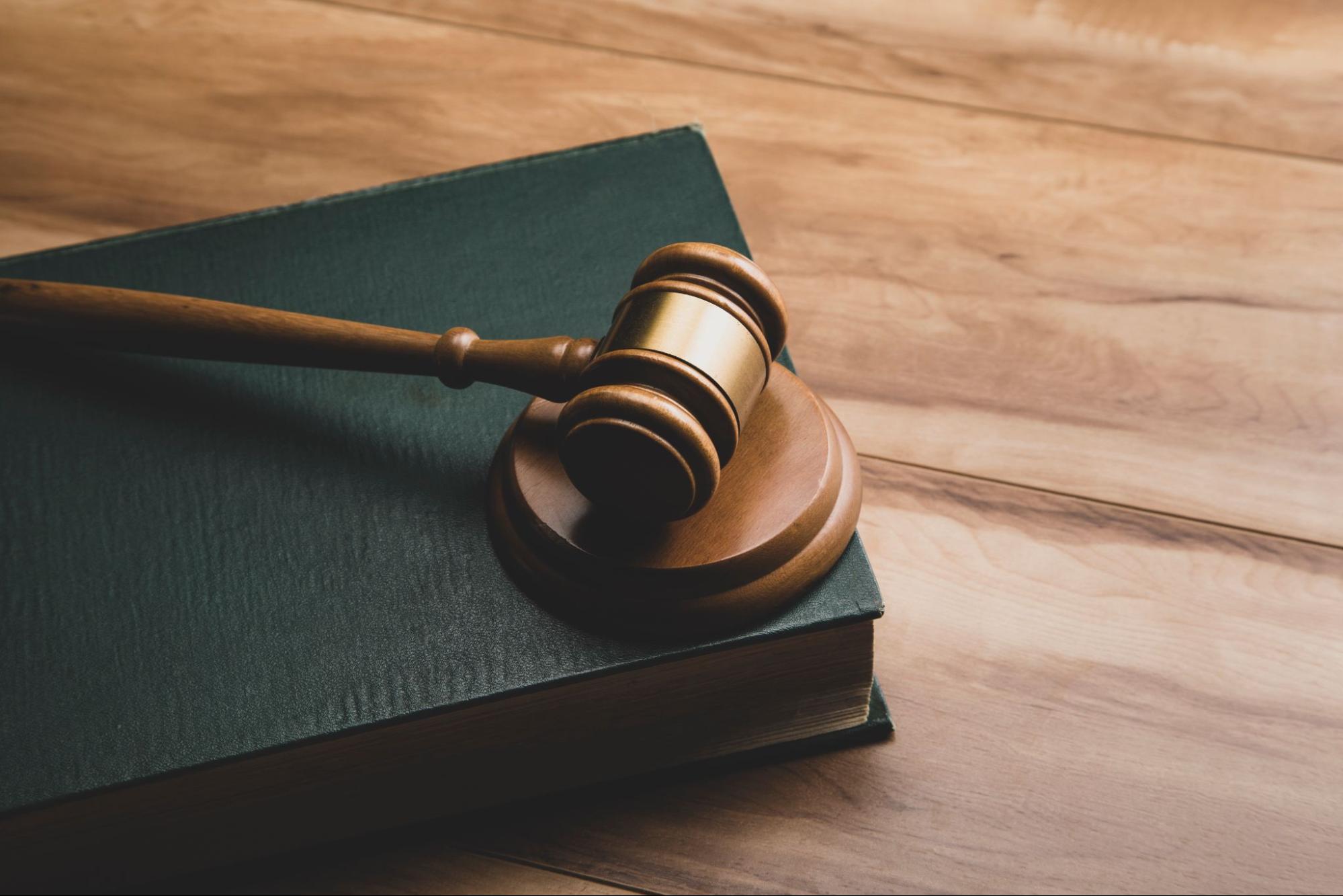 A legal book with a gavel on top